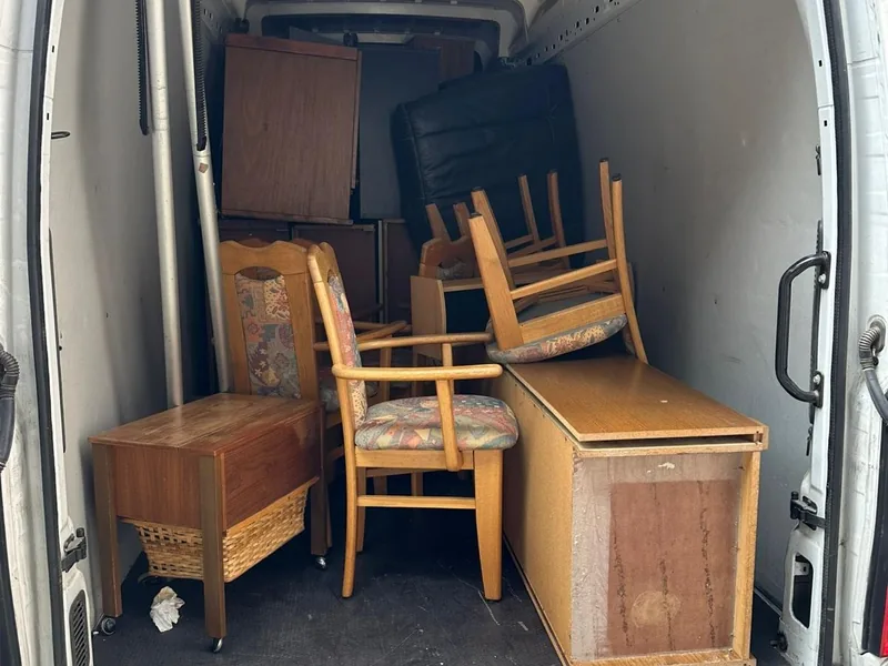 Transporter mit Kommode, Stühlen und Truhe beladen